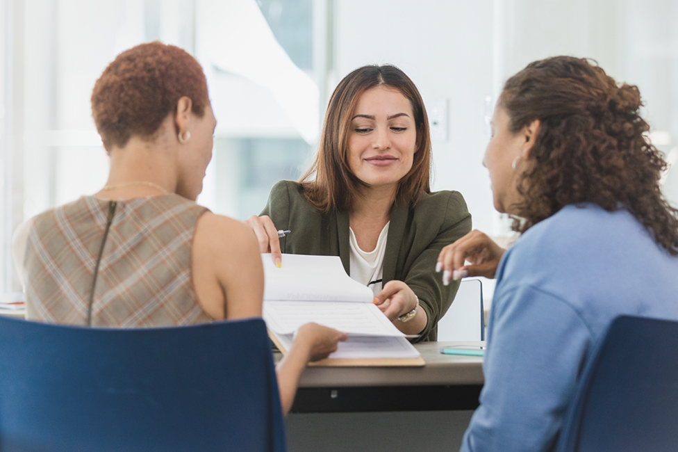female advisor speaking with two female clients