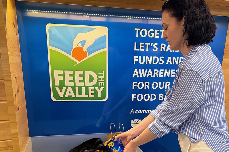 A woman placing a donation into a bin
