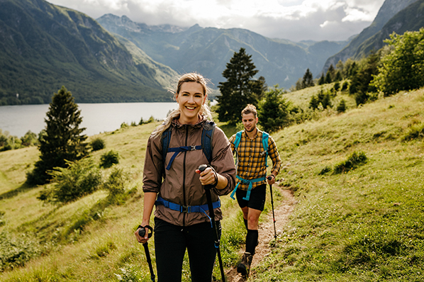 happy young couple hiking in the mountains