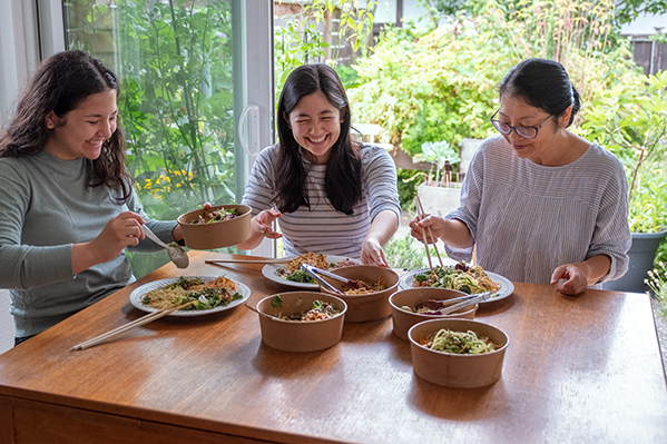 3 different generations of Asian women sitting together having lunch