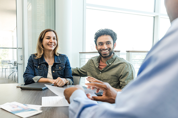 man and woman speaking to an advisor