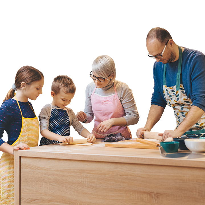 middle aged couple making pizza at home with their kids