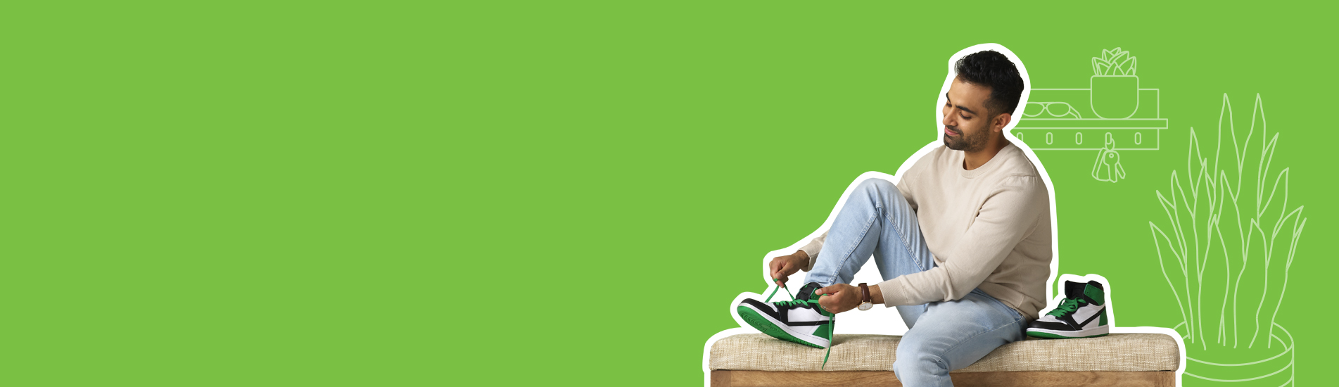 adult South Asian male sitting on a hallway bench tying his green and white sneakers