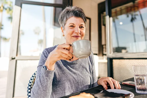 woman having coffee outside patio