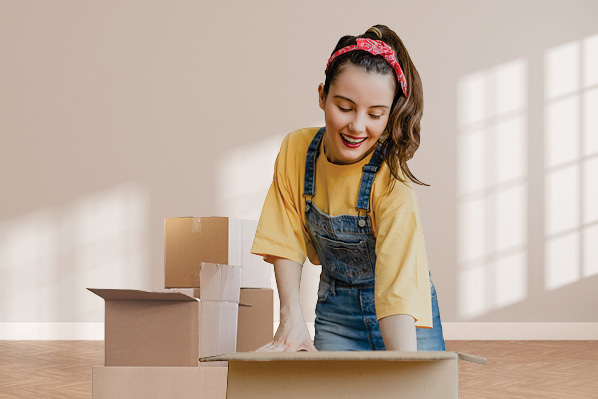 smiling young woman with moving boxes