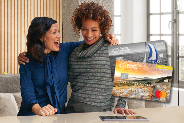 two women hugging and laughing at the kitchen island