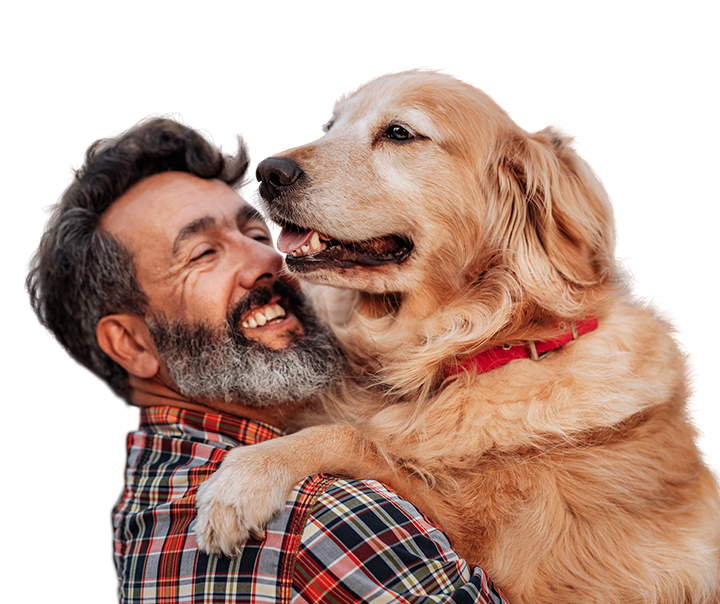 middle aged white man hugging a very large and friendly labrador retriever