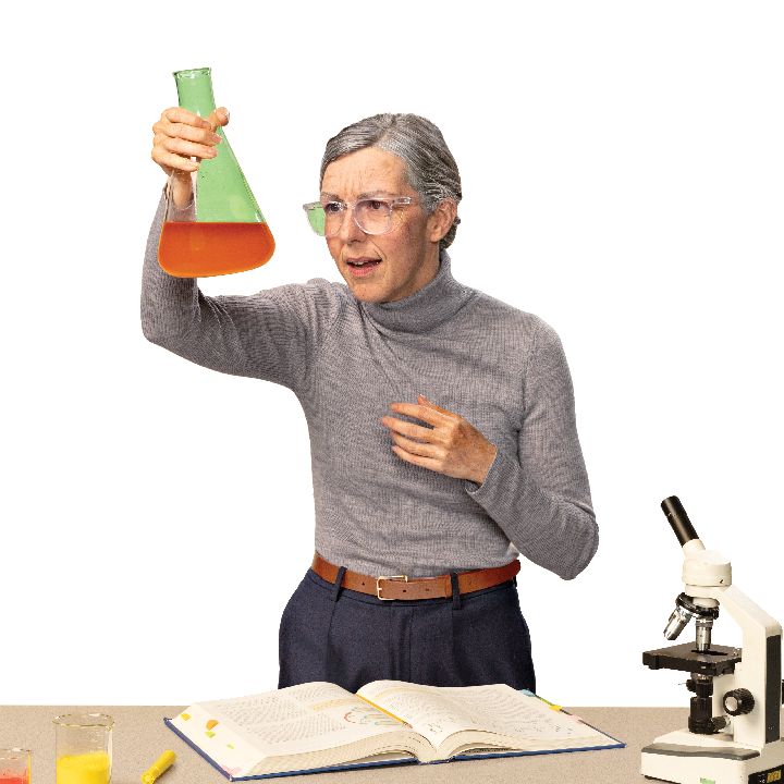 older female science teacher holding up a beaker