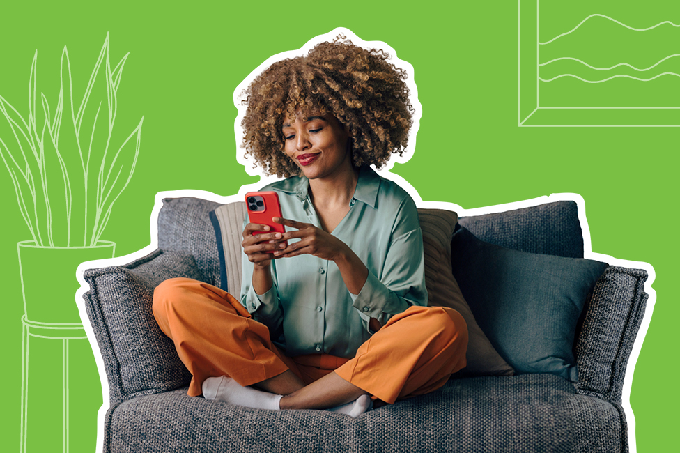 young woman sitting on a comfy chair using her smartphone