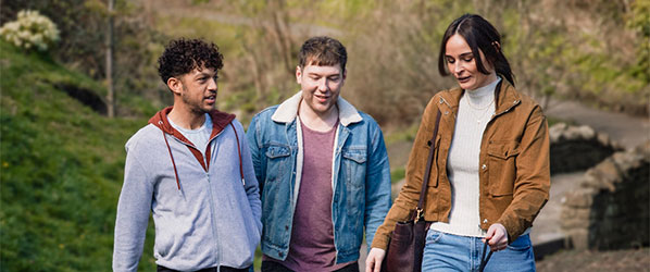 Three friends on a walk with a dog