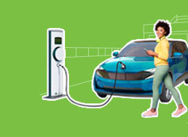 young woman in front of her electric car while it's charging