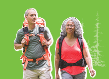 older couple hiking with backpacks