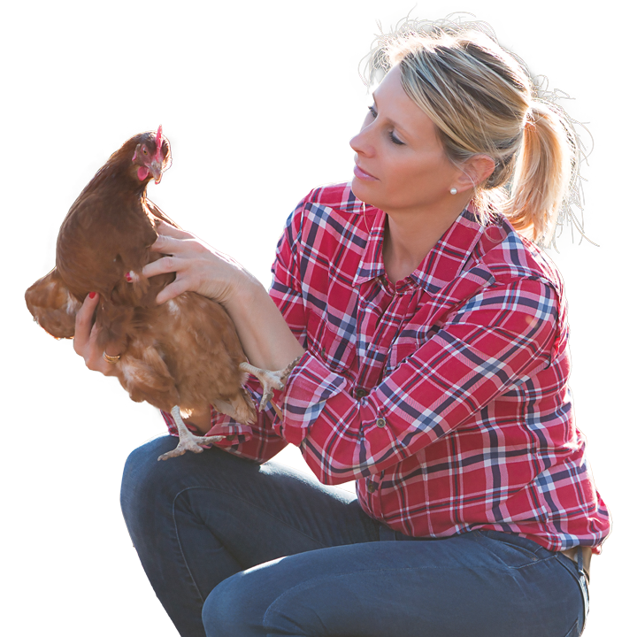 A woman holding a chicken