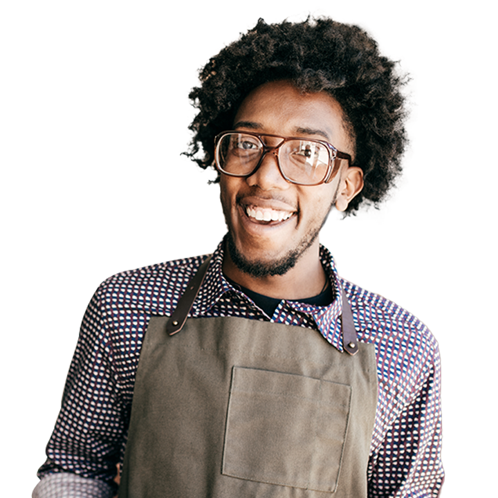 A man wearing an apron and smiling
