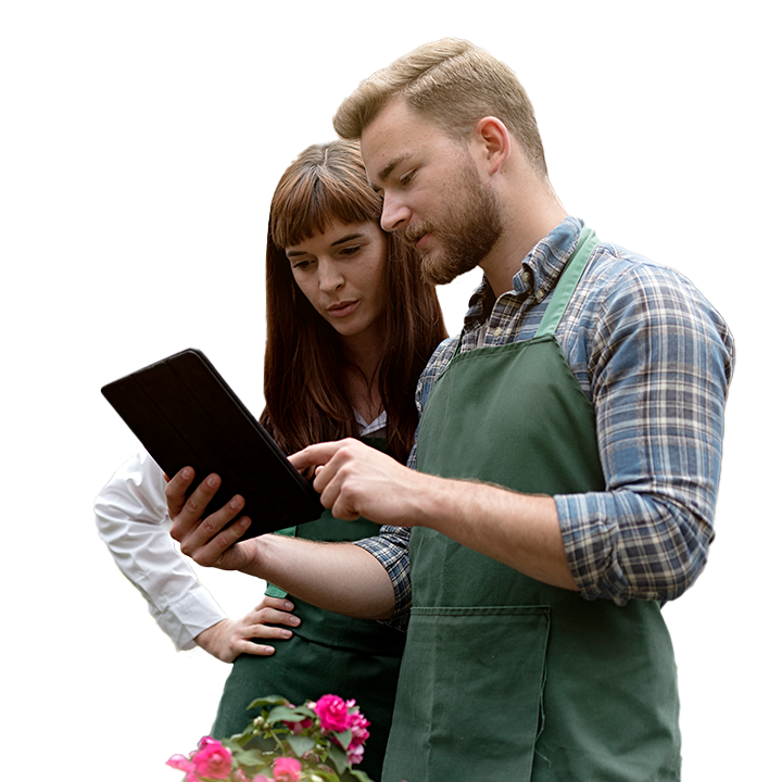 Two business people looking over blueprints on a tablet