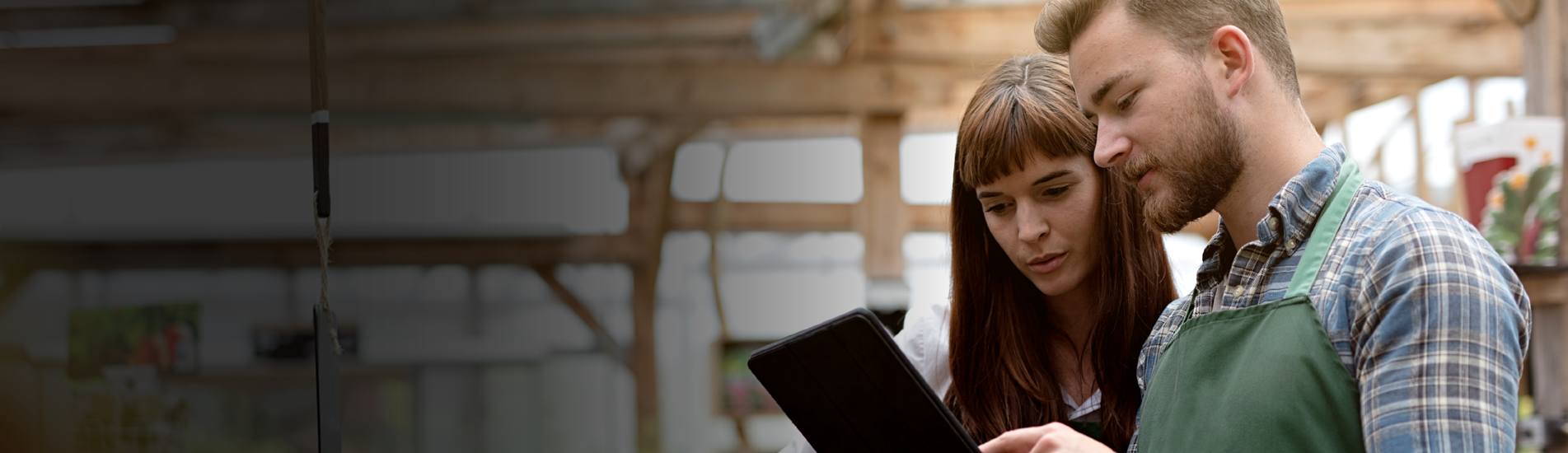 two business partners looking at blueprints on a tablet