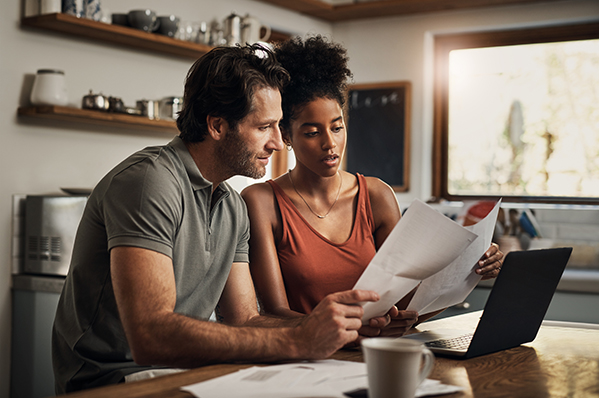 dad explaining finances to his young adult daughter